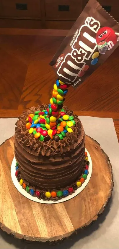 Chocolate cake with an M&M's anti-gravity effect on a wooden platter.