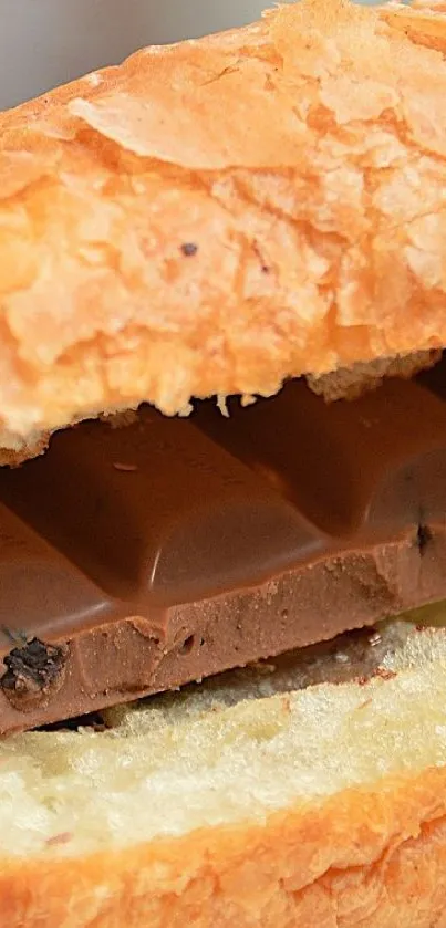 A flaky croissant enveloping a luscious chocolate bar in a close-up view.