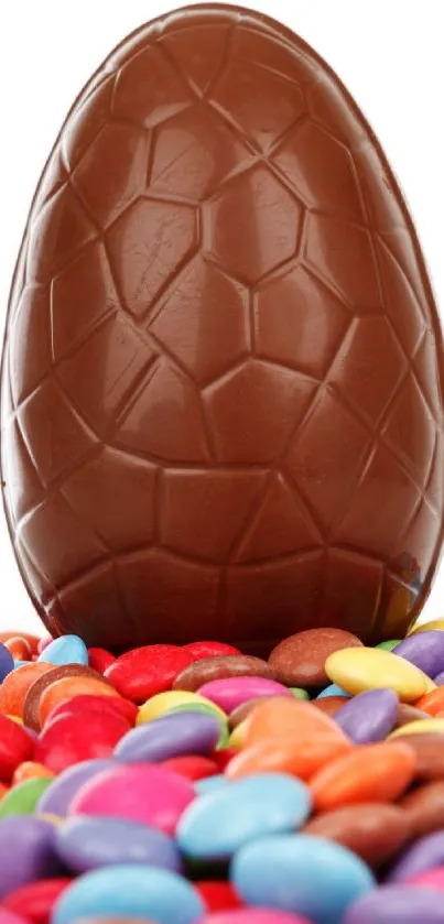 Chocolate egg with colorful candy backdrop.