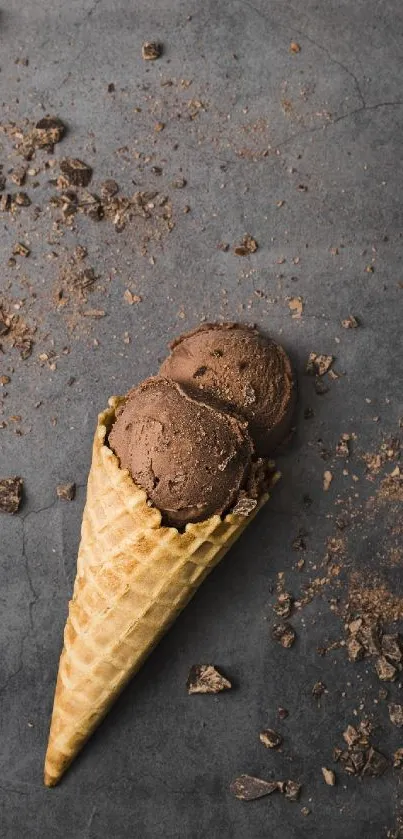 Chocolate ice cream in a waffle cone on a dark background with chocolate pieces.