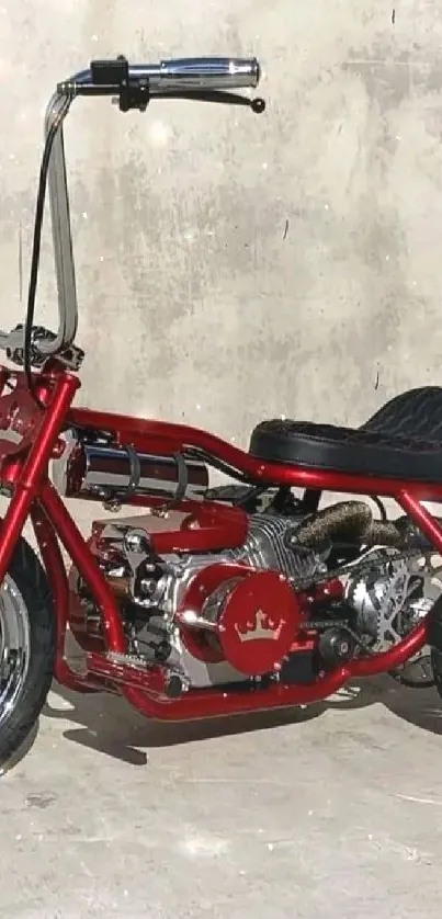 Red chopper bike on concrete background with chrome highlights.