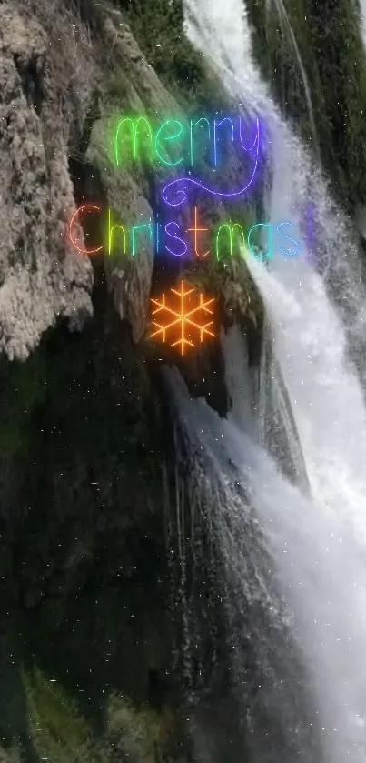 Christmas waterfall with neon text and snowflake on rock.