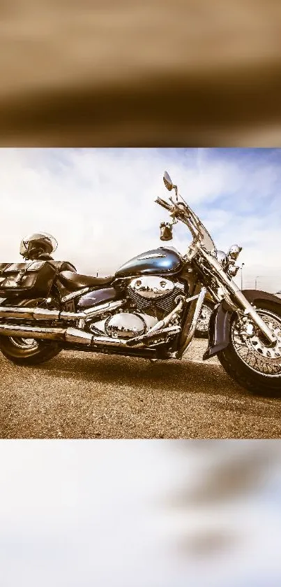 Shiny chrome motorcycle on an open road with a bright, clear sky.