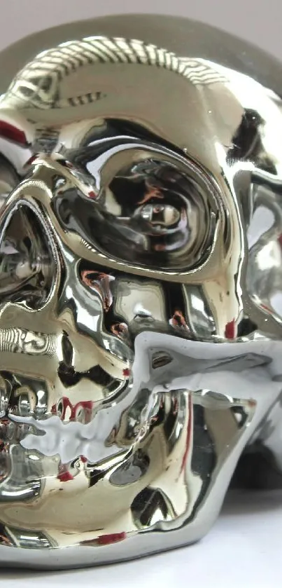 Metallic chrome skull art on white background.