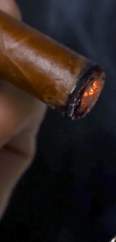 Close-up of a cigar being lit, with glowing embers.