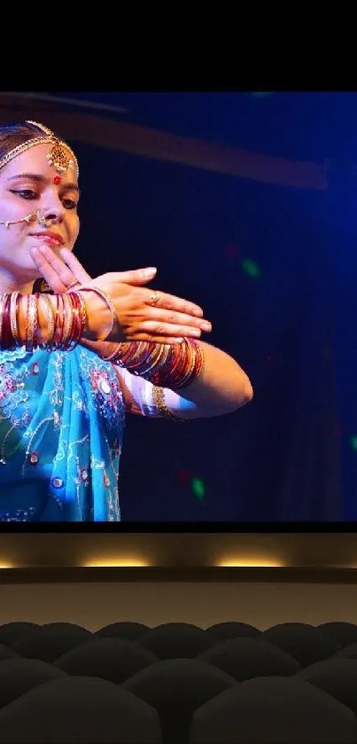 Traditional dancer performing on a theater screen with vibrant colors.