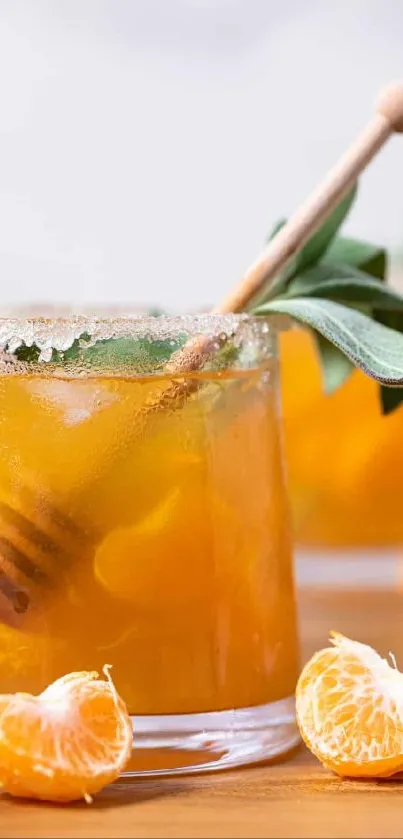 Refreshing citrus drink with honey stick and garnish.