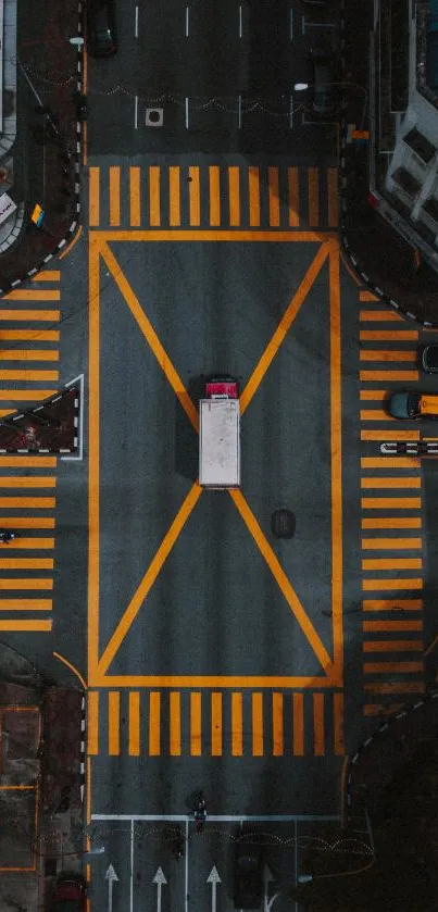 Aerial view of a city intersection with vibrant traffic patterns and buildings.