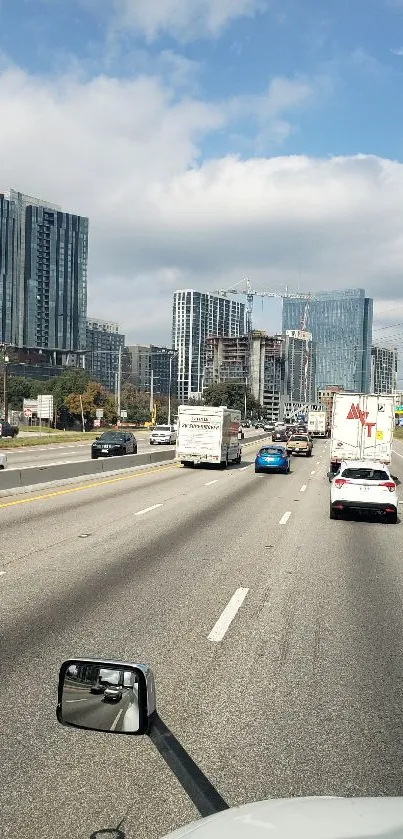 Busy city highway with cars and skyscrapers under a clear sky.