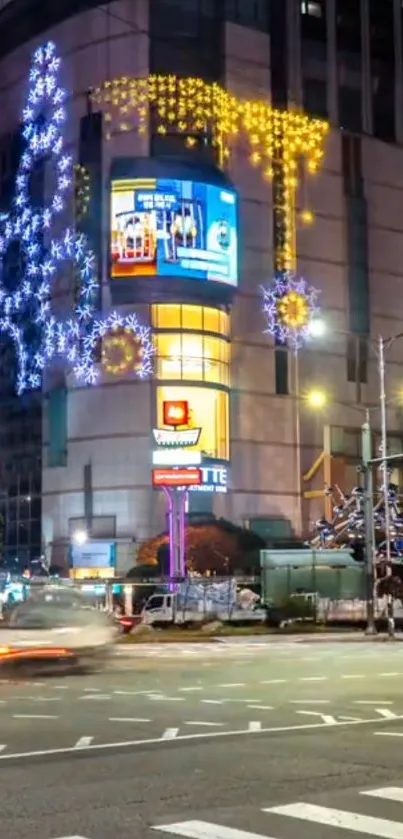 Vibrant city street at night with colorful lights and festive decorations.