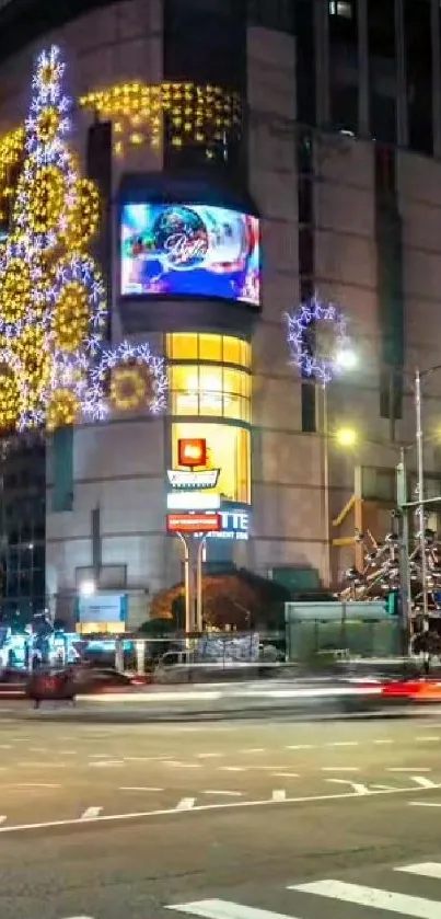 Illuminated urban street with festive lights and decorations.