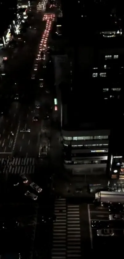 Aerial night view of a city street with lights.