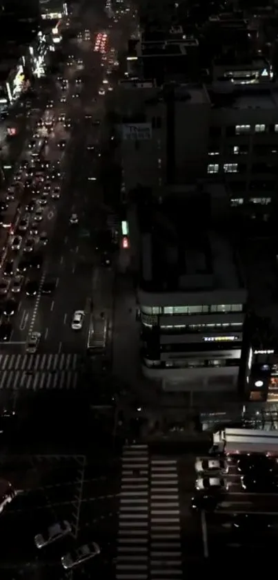 Aerial view of city night streets with glowing lights and bustling traffic.