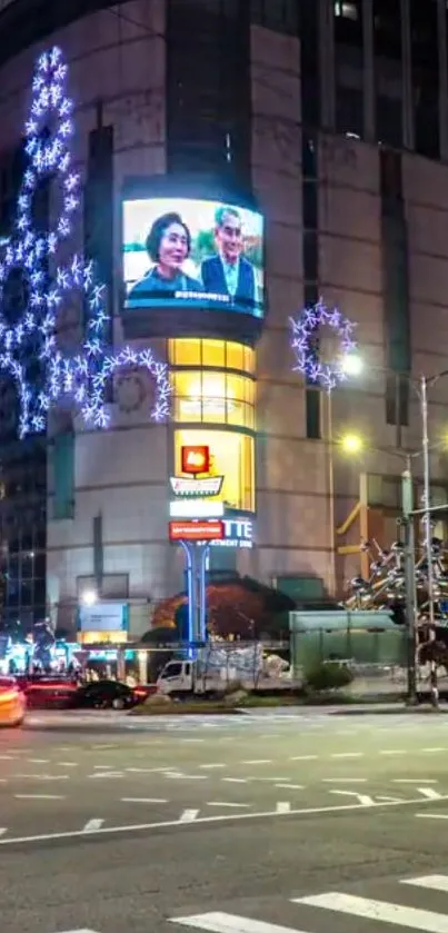 City at night with glowing lights and festive decorations, captured on a busy street.