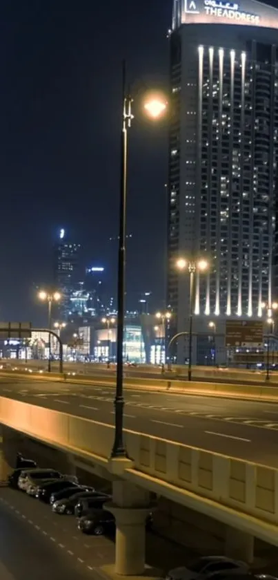 Urban cityscape at night with illuminated skyscrapers and streetlights.