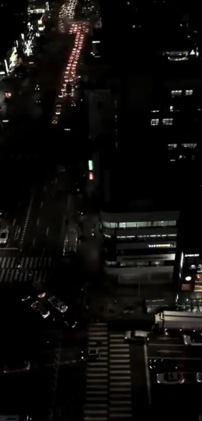 Aerial view of a city at night with traffic and lights.