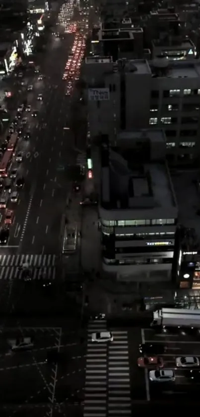 Nighttime aerial view of a bustling city street with lights.