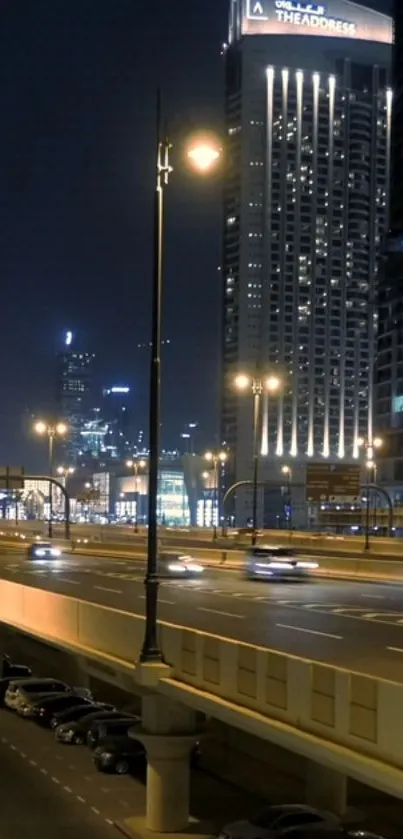 Nighttime cityscape with highway lights and skyscrapers.