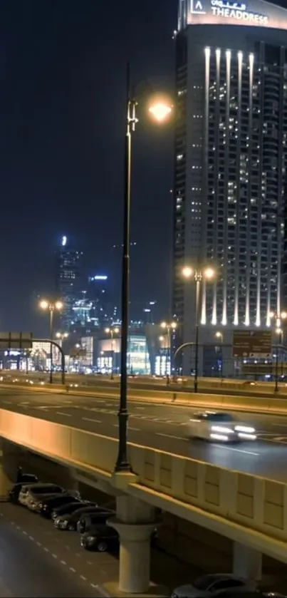 City nightscape with illuminated buildings and street lights.