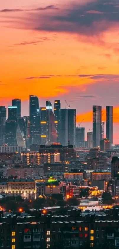 City skyline under vibrant orange sunset sky.