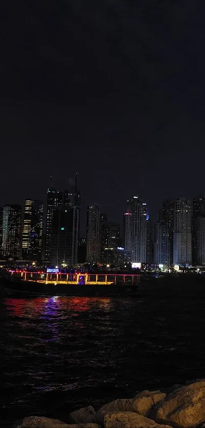 Night city skyline with lights reflecting on water.