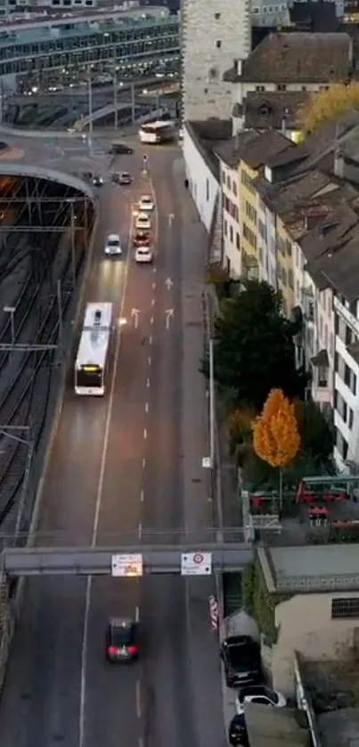 City street with cars and railway in urban setting.