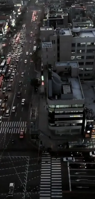 A city street at dusk with busy traffic and illuminated buildings.