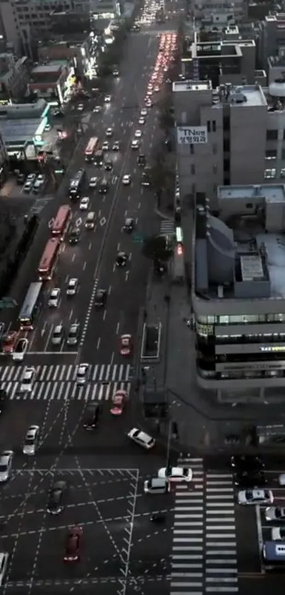 Aerial view of a busy city street at dusk with glowing lights.