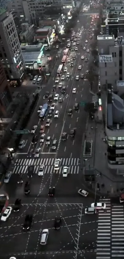 Aerial view of a bustling city street at night, with vibrant lights and traffic.