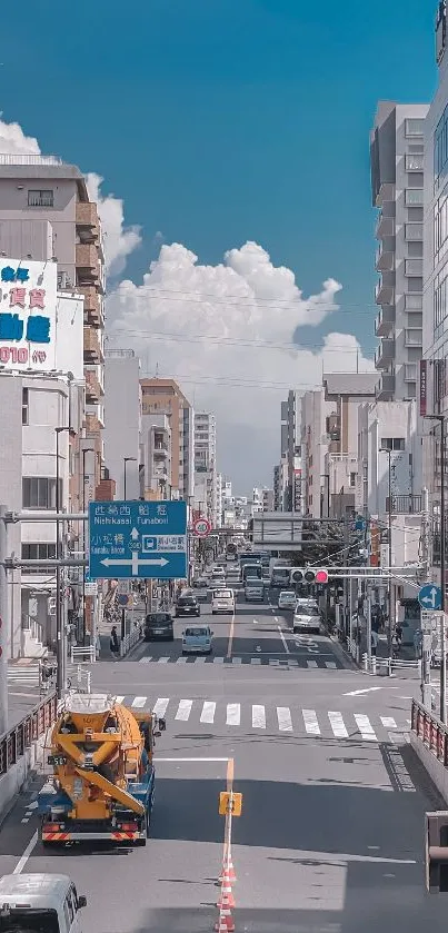 City street view with tall buildings under a blue sky.