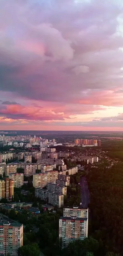 Cityscape under a dreamy pink sunset sky with urban skyline.