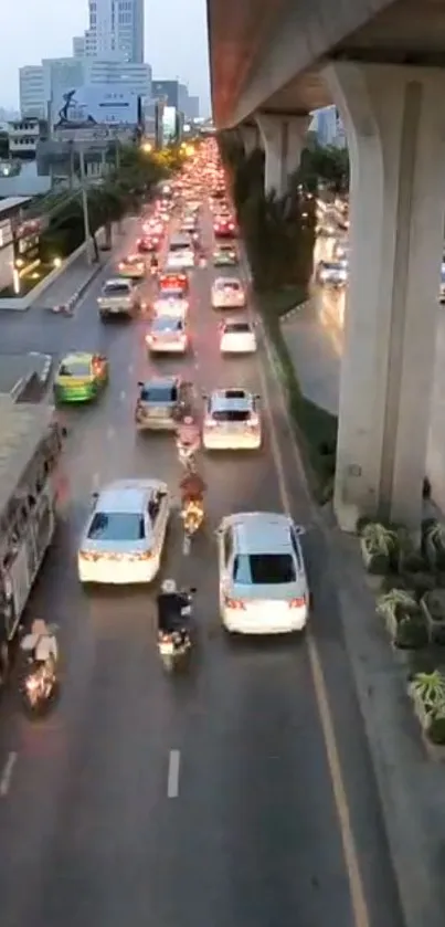 Aerial view of bustling city traffic with cars and bikes in motion.