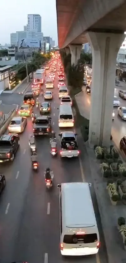 Busy evening city traffic under skytrain.