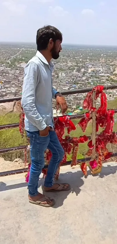 Man standing by city view with red decorations.