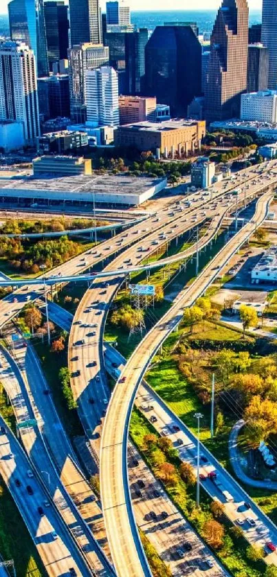 Aerial view of bustling city highways with a vibrant skyline.