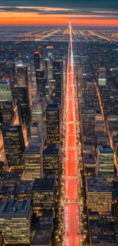 Aerial cityscape view with a vibrant sunset over an illuminated urban skyline.