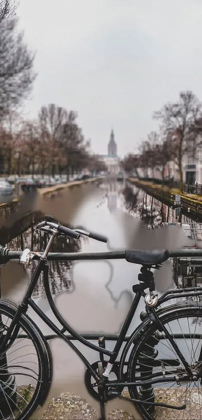 City bicycle by a tranquil canal with scenic background.