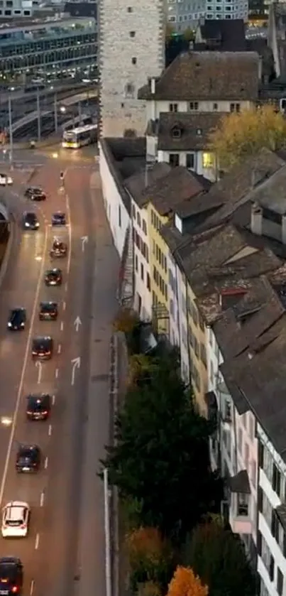 Evening cityscape with road and rooftops.