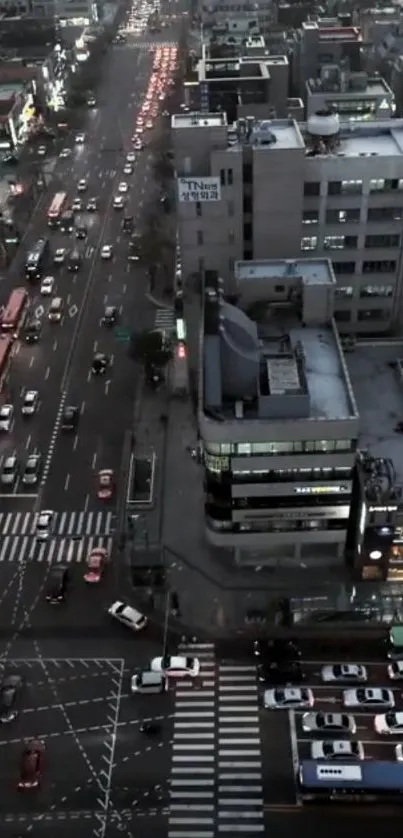 Aerial view of a cityscape with evening traffic and urban lights.