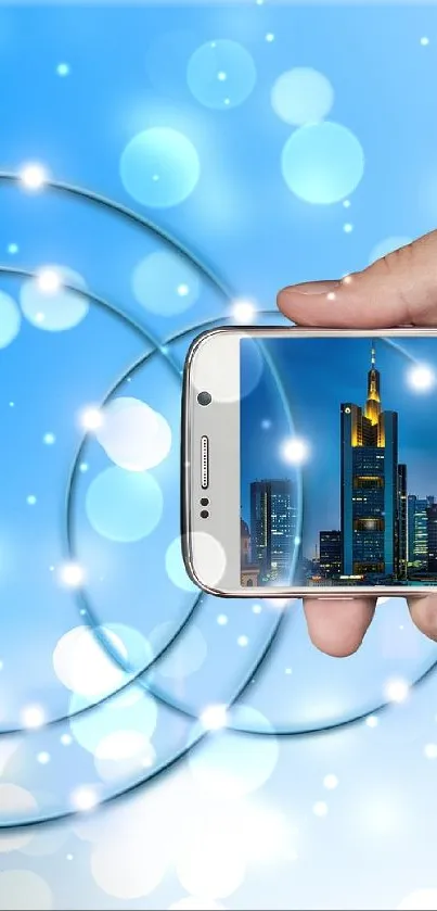 Hand holding smartphone with cityscape digital background in blue tones.