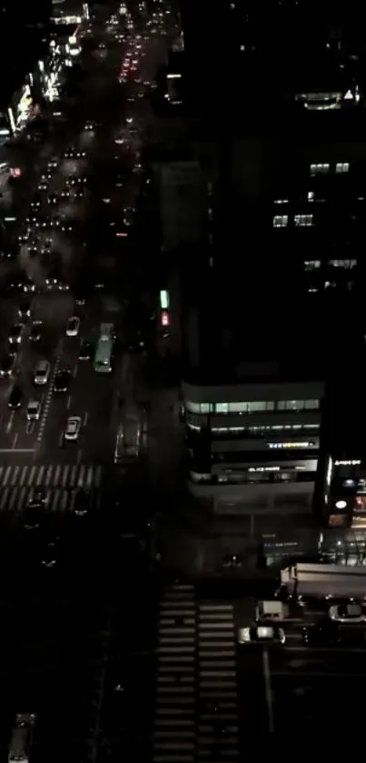 Aerial night view of a city with glowing streets.