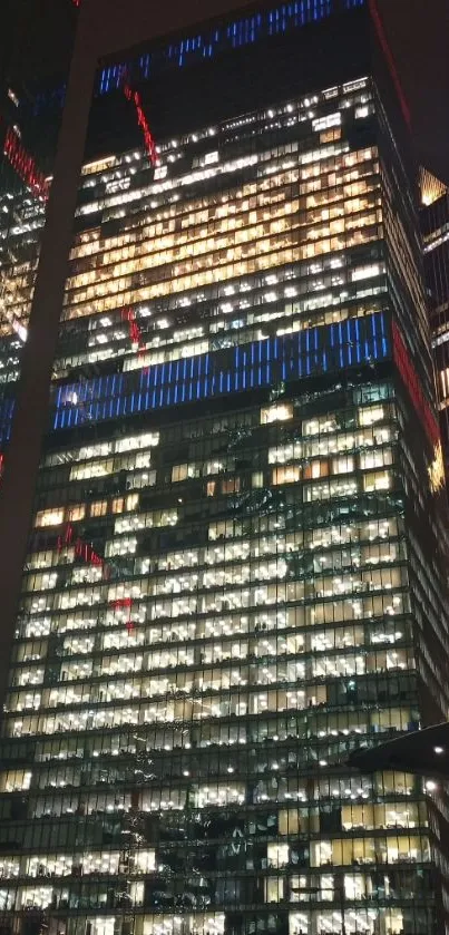 Night cityscape with illuminated skyscrapers and colorful lights.