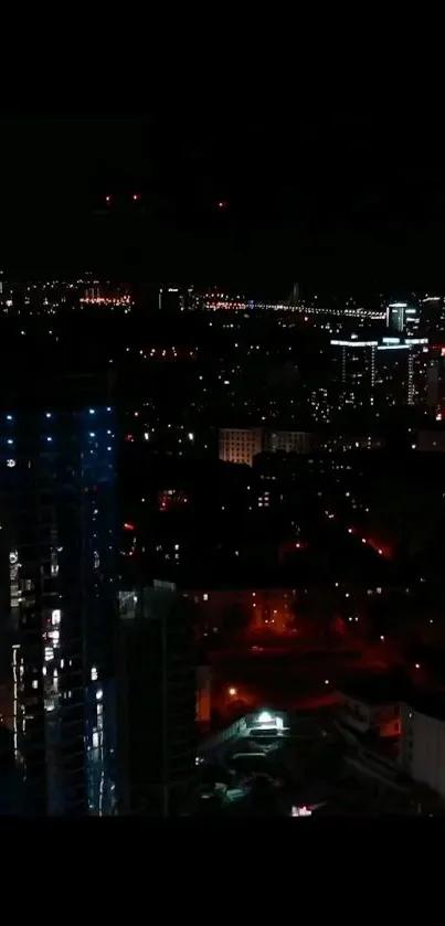 Night cityscape with glowing lights and tall buildings.