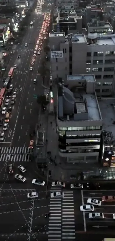 Aerial view of city traffic and buildings at night.