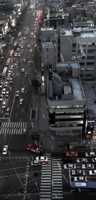A nighttime aerial view of a bustling city street with traffic lights and vibrant roads.