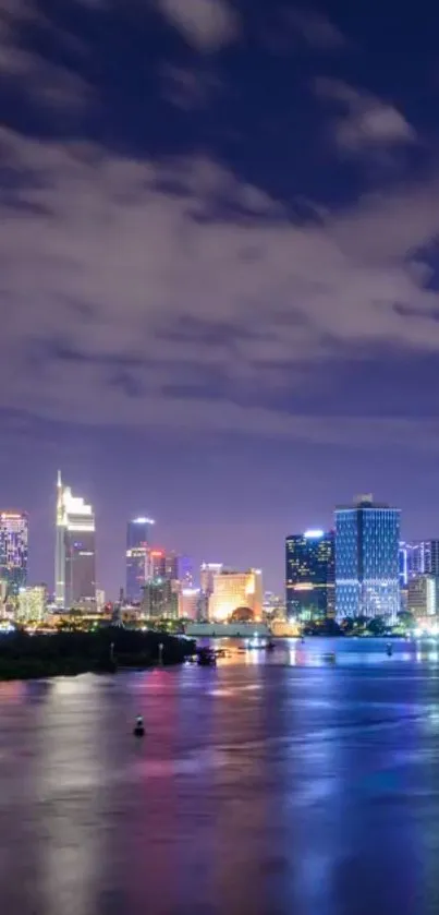 Serene city skyline at night reflected on calm water, with vibrant urban lights.