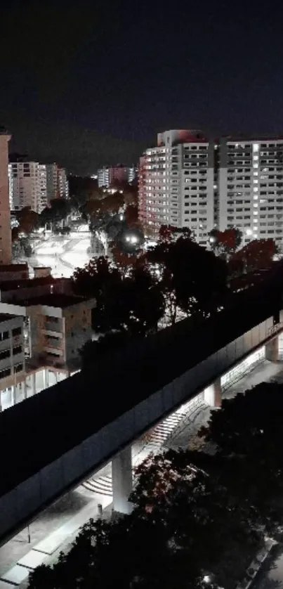 Nighttime cityscape with lit buildings and dark sky.