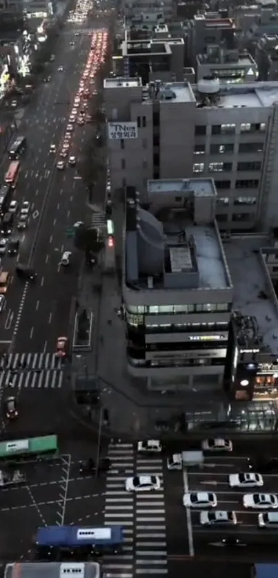 Overhead view of city streets and buildings at night with vibrant lights.