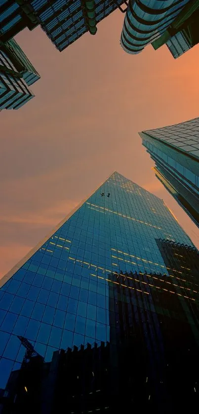 Stunning cityscape at sunset with skyscrapers and a vibrant orange sky.