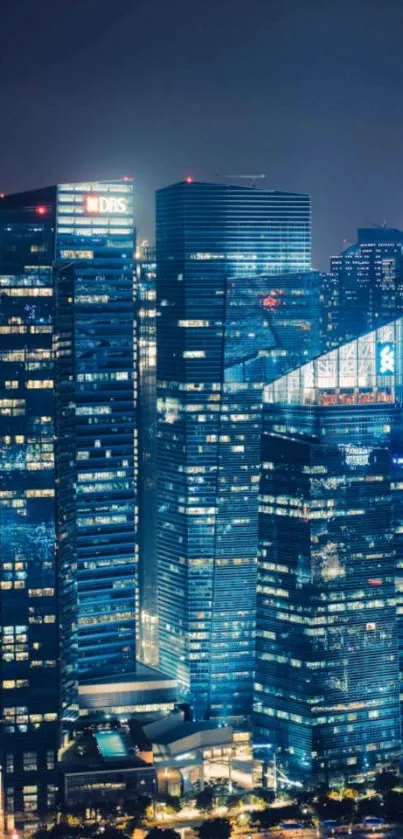 Cityscape at night with glowing skyscrapers and dark sky.